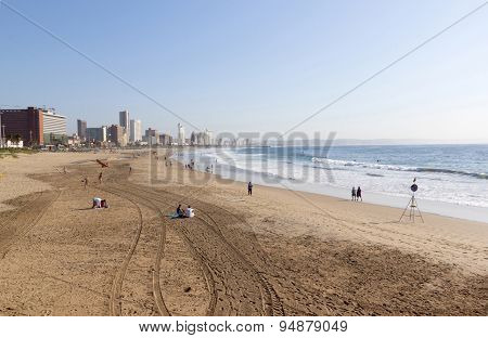 Morning Tyre Tracks And People On Beach In Durban