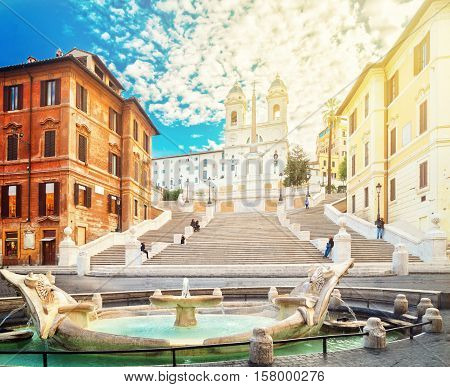 famous Spanish Steps with fountain with sunshine, Rome, Italy