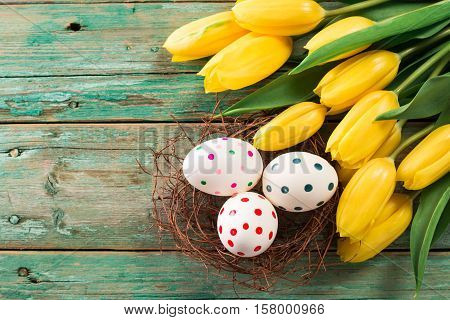 Easter Background Yellow Tulips On Wooden Table, Rabbit, Eggs,nest Candy