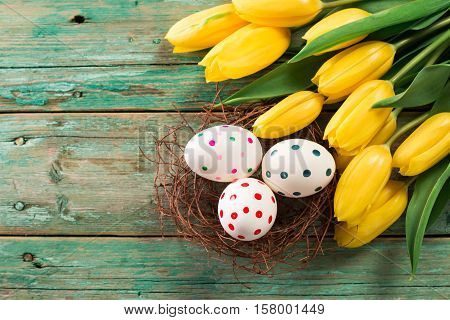 Easter Background Yellow Tulips On Wooden Table, Rabbit, Eggs,nest Candy