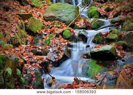Small watterfall in the middle of autumn.