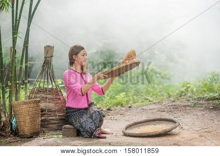Beautiful Thai Asian Women Winnow Rice Separate Between Rice And Rice Chaff Identity . In Traditiona