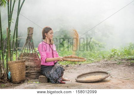 Beautiful Thai Asian Women Winnow Rice Separate Between Rice And Rice Chaff Identity . In Traditiona