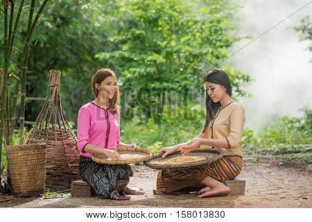 Beautiful Thai Asian Women Winnow Rice Separate Between Rice And Rice Chaff Identity . In Traditiona
