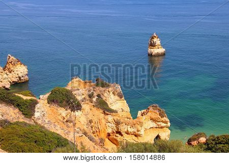 Camilo beach and rocky sea coast in Lagos, Algarve, Portugal