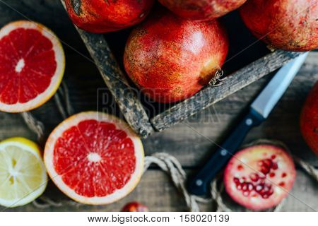 Ripe Pomegranate Fruit On Wooden Vintage Background. Red Juice P