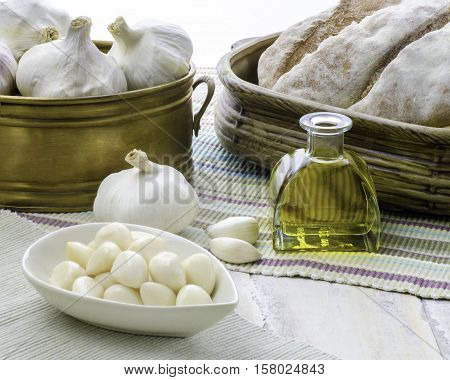 An arrangement of garlic including whole cloves and pickled set in a kitchen on a wooden table copy space bottom right
