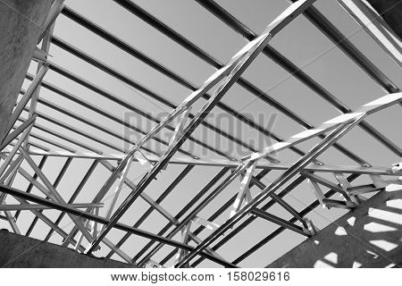 Black and white photoStructure of steel roof frame for building construction.