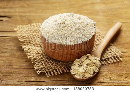 Natural organic Oat flour in a wooden bowl