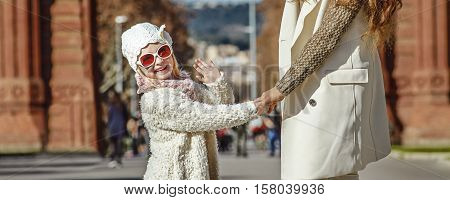 Mother And Child Near Arc De Triomf In Barcelona Handwaving