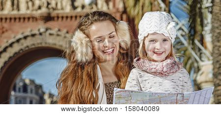 Mother And Daughter Near Arc De Triomf Looking At Map