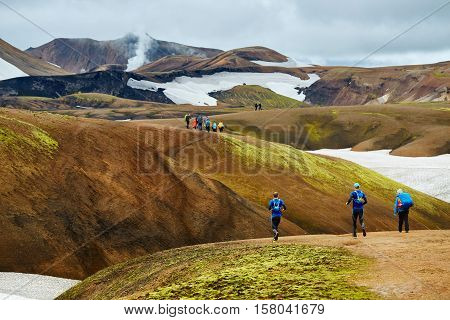hikers on the trail in the Islandic mountains. Trek in National Park Landmannalaugar, Iceland