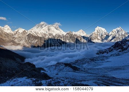 Mount Everest View From Renjo La Pass. Breathtaking Mountain Valley Filled With Curly Clouds. Dramat