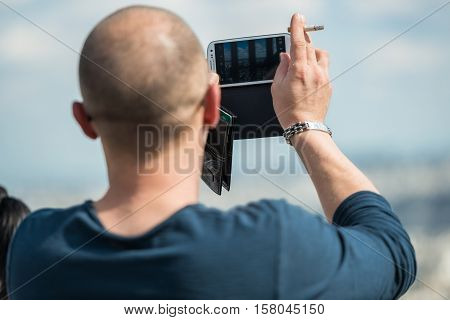 Paris, France- June 30, 2013: Man Take A Picture Of Monuments Of Paris With His Phone, From The Top