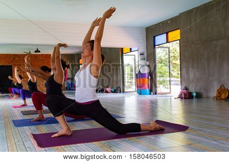 Group of women doing yoga in a fitness gym.