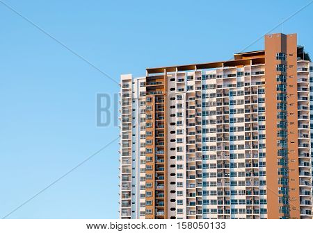 Condominium or apartment building with blue sky background