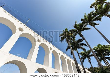 Carioca Aqueduct, Also Known as Arch of Lapa, in the Blue Sky, with Palm Trees, Rio de Janeiro, Brazil