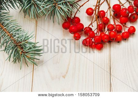 Christmas mokup.Tree branch frame with rowanberry .White wooden table.Top view
