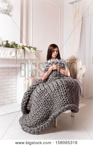 Girl with large grey knit blanket giant knit blanket super chunky yarn arm knitting
