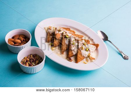 Shahi Tukda prepared - deep fried bread in ghee, garnish with sweetened cream and dry fruits.