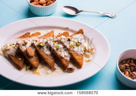 Shahi Tukda prepared - deep fried bread in ghee, garnish with sweetened cream and dry fruits.