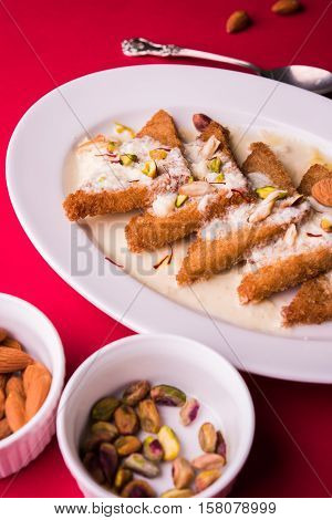Shahi tukda prepared - deep fried bread in ghee, garnish with sweetened cream and dry fruits.