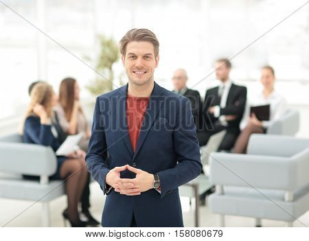 Portrait of happy businessman with  colleagues interacting on ba