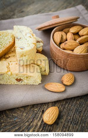 Italian cantuccini cookies with almonds. Traditional italian almond cookies biscotti on old wooden background. Homemade Almond cookies on wooden table. Delicious cookies biscotti. Selective focus.