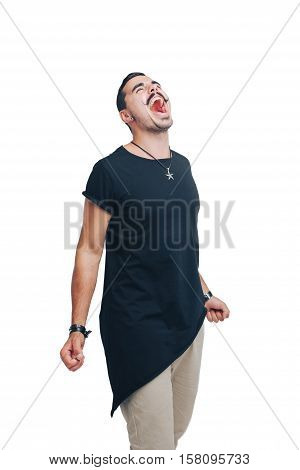 young emotional guy with a mustache in a black shirt screams angrily smiling, arms outstretched