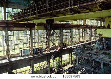 Abandoned, destroyed by war and overgrown machinery of Tkvarcheli power plant, Abkhazia, Georgia