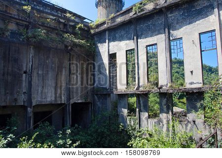 Abandoned, destroyed by war and overgrown machinery of Tkvarcheli power plant, Abkhazia, Georgia