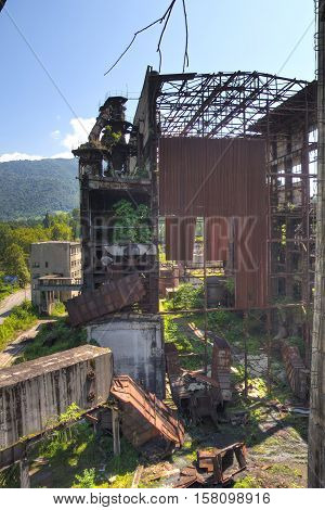 Abandoned, destroyed by war and overgrown machinery of Tkvarcheli power plant, Abkhazia, Georgia