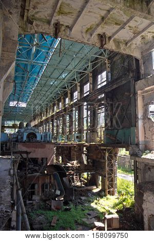 Abandoned, destroyed by war and overgrown machinery of Tkvarcheli power plant, Abkhazia, Georgia