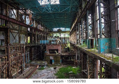Abandoned, destroyed by war and overgrown machinery of Tkvarcheli power plant, Abkhazia, Georgia