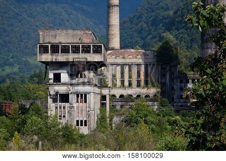 Abandoned, destroyed by war and overgrown machinery of Tkvarcheli power plant, Abkhazia, Georgia