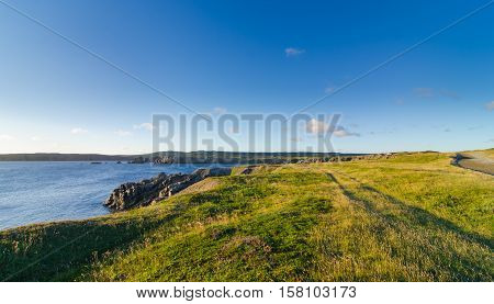 Road to Cape Bona Vista lighthouse station, Newfoundland,  Panoramic vista, bright blue late summer morning over Atlantic Canada.