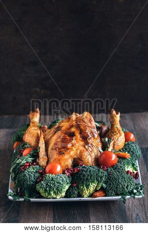 Roasted Chicken With Vegetables On Wooden Table