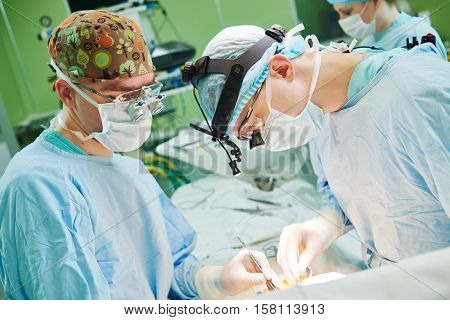 male cardiac surgeon at child cardiosurgery operating room