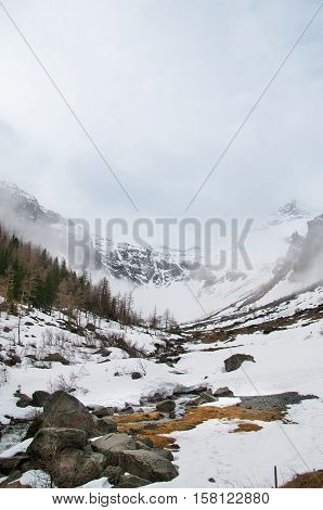 Scenic picture-postcard view of famous place, Grossglockner mountain with cloud & fog, Austria