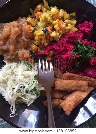 Macrobiotic meal on black plate
