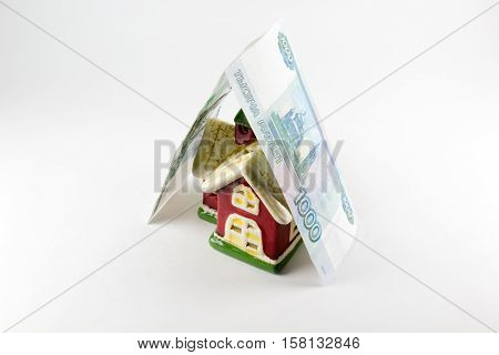 House and one thousand rubles money on a white background