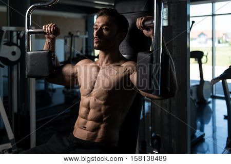 Man Doing Butterfly Chest Exercise On Machine