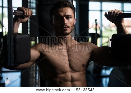 Man Doing Butterfly Chest Exercise On Machine