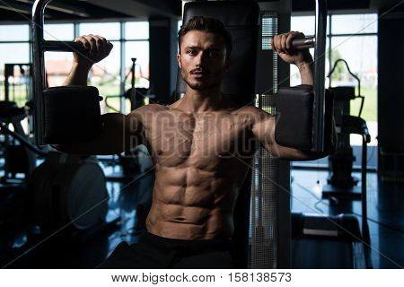 Man Doing Butterfly Chest Exercise On Machine