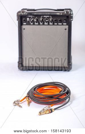 Close-up of guitar amplifier with jack cable.