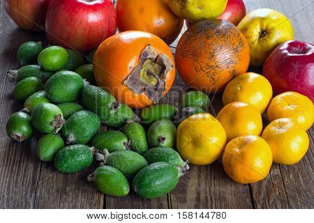 Mixed exotic fruits on wooden background. Close up