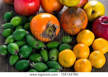 Mixed exotic fruits on wooden background. Close up
