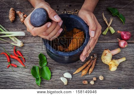 The Women Hold Pestle With Mortar And Spice Paste . Red Paste Ingredients For Red Curry On Rustic Wo