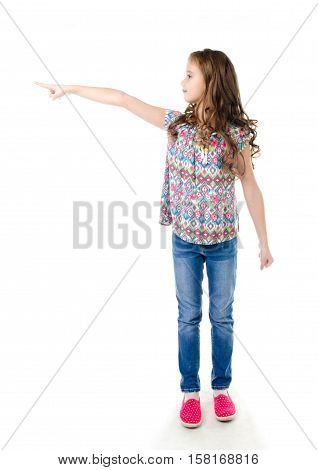 Cute little girl is pointing to the side isolated on a white