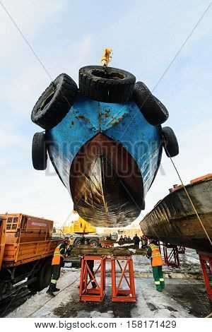 MOSCOW, RUSSIA - NOVEMBER 11, 2016: State Unitary Enterprise Mosvodostok performs recovery vessels on coastal winter parking. Workers take the ship to berth.